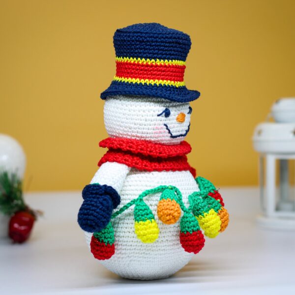 crochet snowman with festive christmas light bulbs