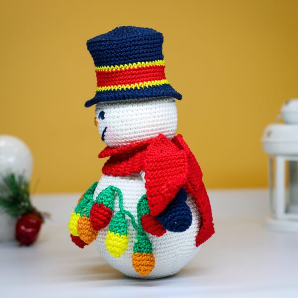 crochet snowman with festive christmas light bulbs