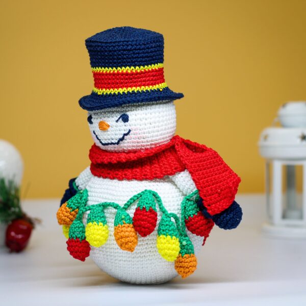 crochet snowman with festive christmas light bulbs
