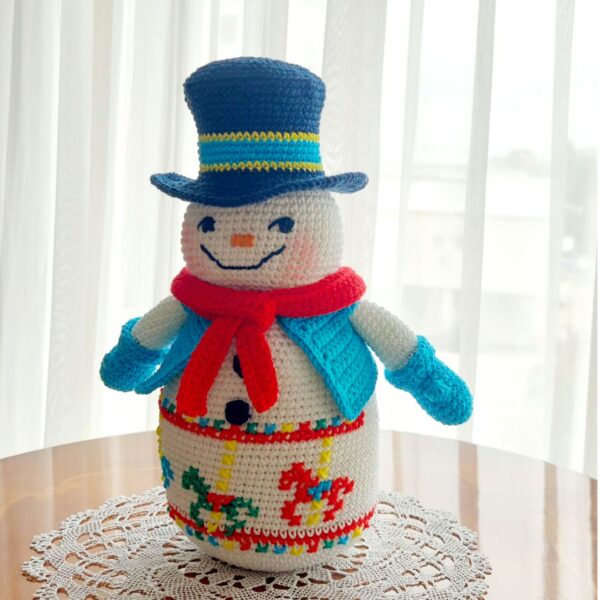 crochet snowman with embroidered carousel horses